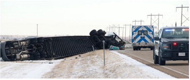 Driver Charged After Semi Rollover